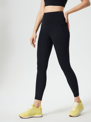 Black high-waisted leggings with subtle pocket detail and a sculpted fit.
