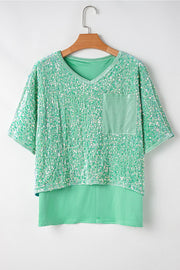 Sequin embellished dolman sleeve top in gum leaf green with a chest pocket.