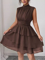 Brown sleeveless ruffle tiered dress with ruched waist and mock neck.