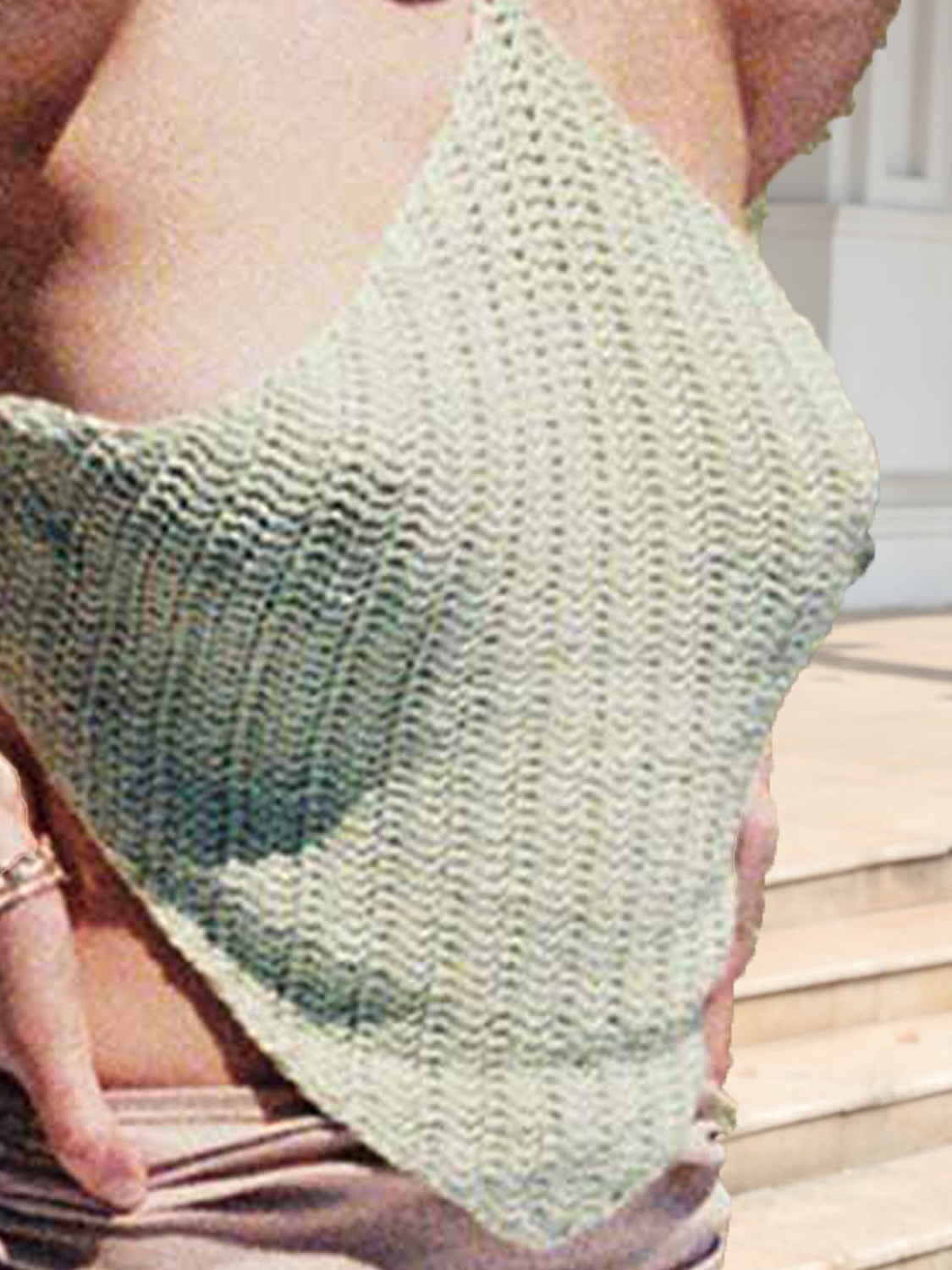 Crochet halterneck triangle top in light green with a backless design.