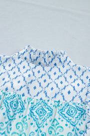 Patchwork mini dress with ruffled mock neck and blue ikat print.