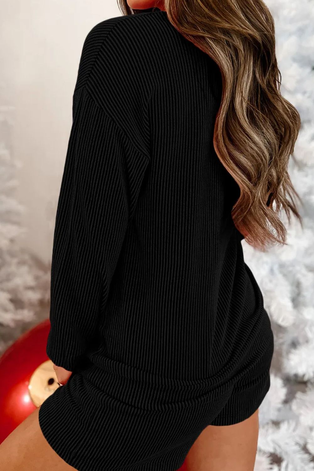 Black ribbed loungewear set with long sleeves and shorts.