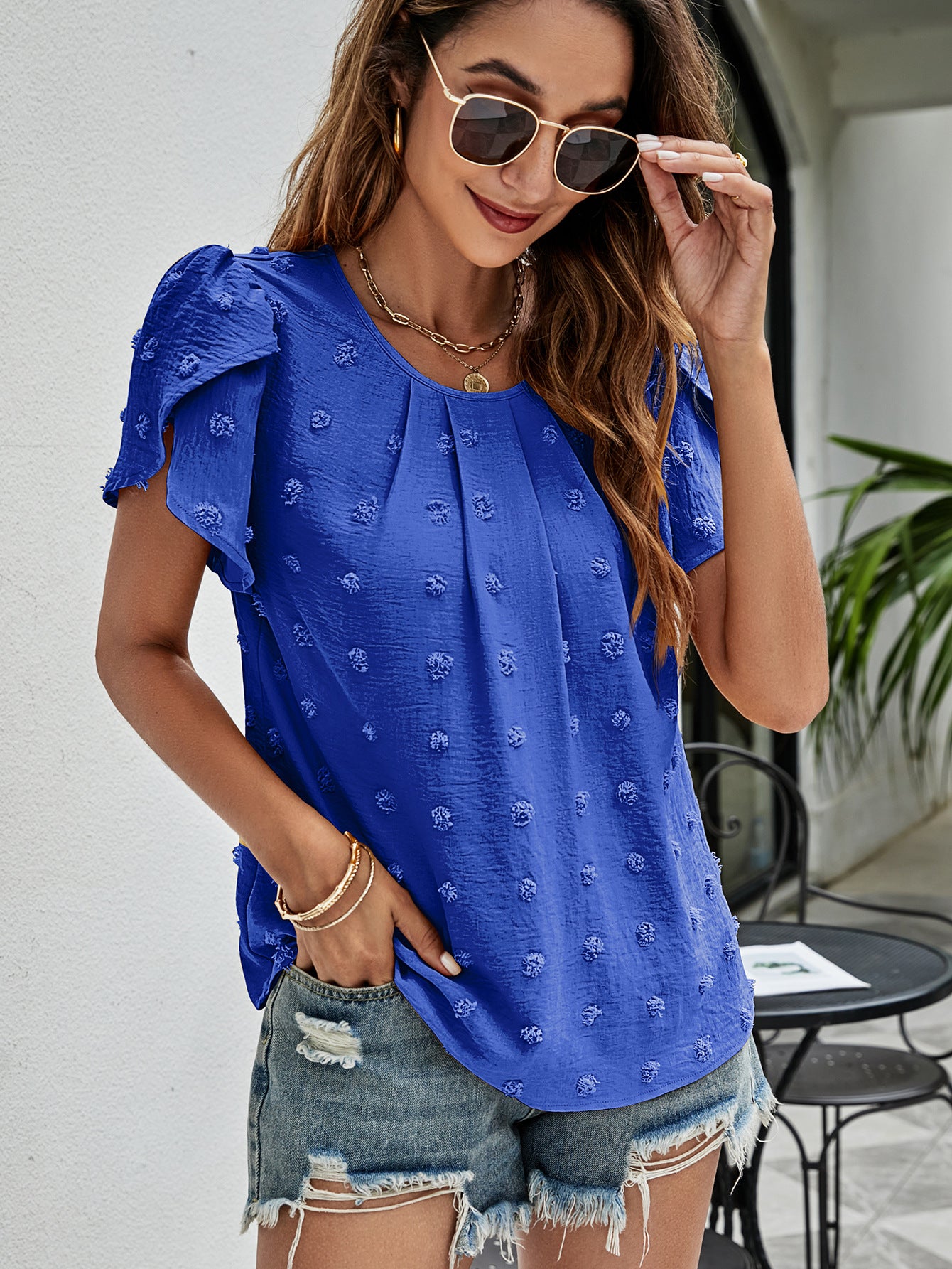 Royal blue textured puff sleeve blouse with dot pattern and pleated front.