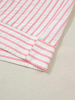 Pink and white striped seersucker blouse with textured fabric detail.
