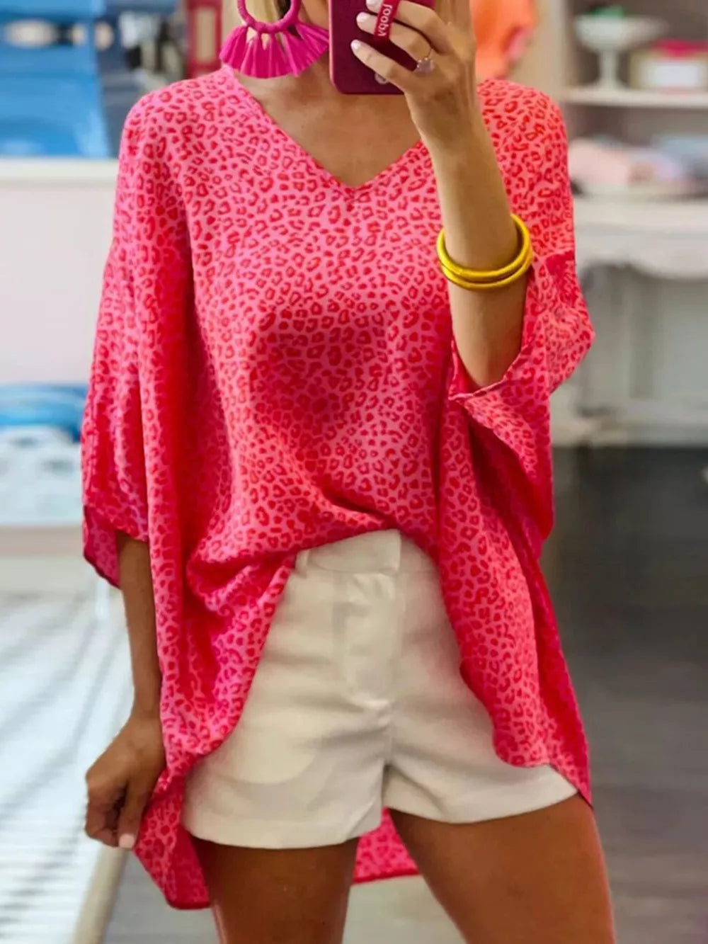 Pink leopard print V-neck maternity shirt with knot detail and relaxed fit.