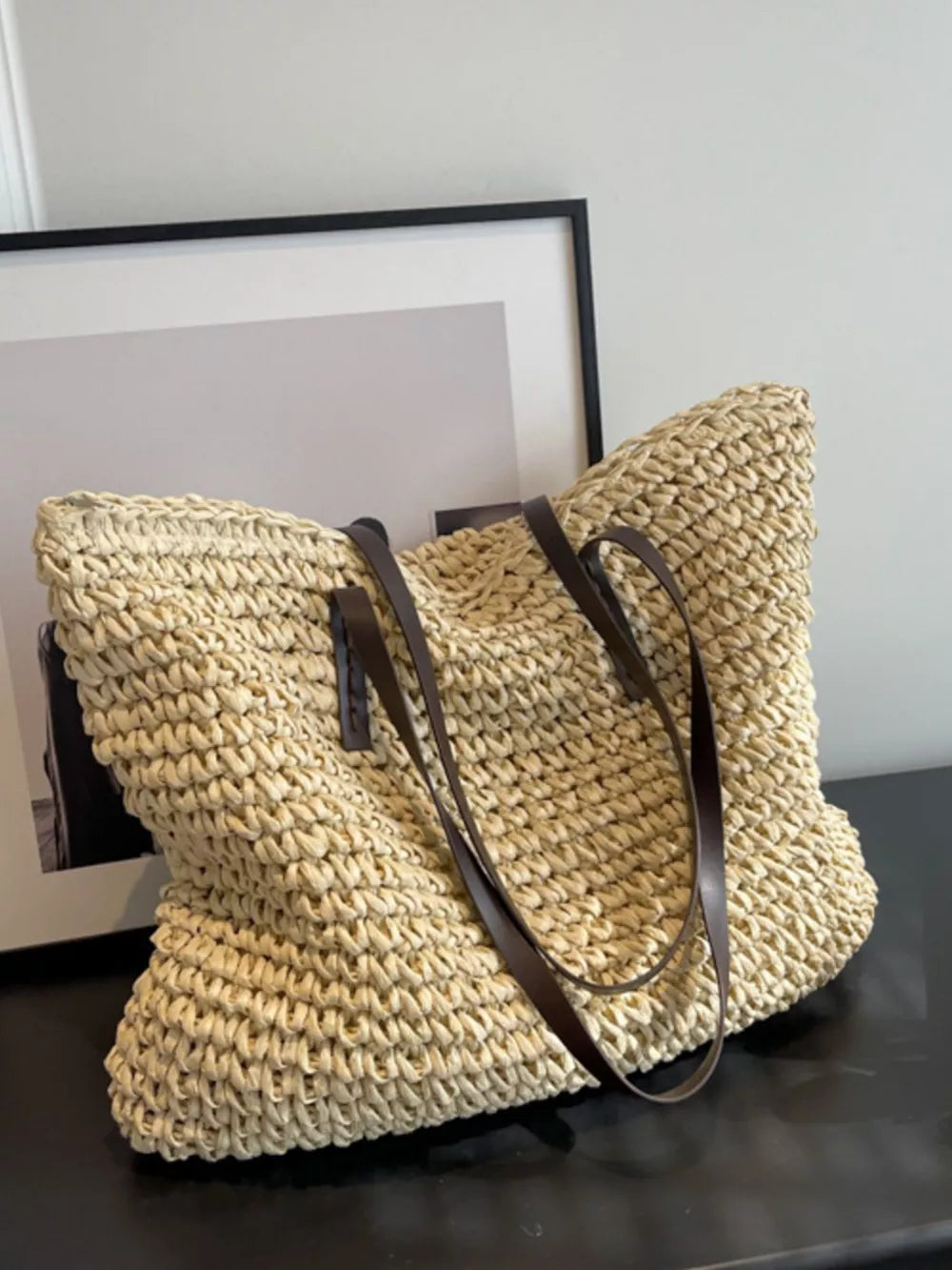 Natural woven straw shoulder bag in Khaki with brown leather straps.