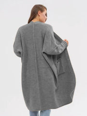 Oversized gray acrylic knit cocoon cardigan with pockets and ribbed cuffs.