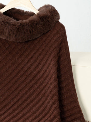 Chocolate knit poncho with faux fur trim and diagonal ribbing detail.