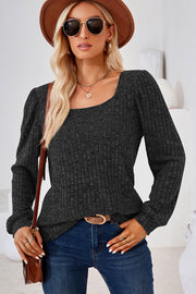 Black ribbed square neck top with puffed sleeves and long sleeves.