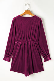 Burgundy velvet wrap romper with ruffled cuffs and cinched waist