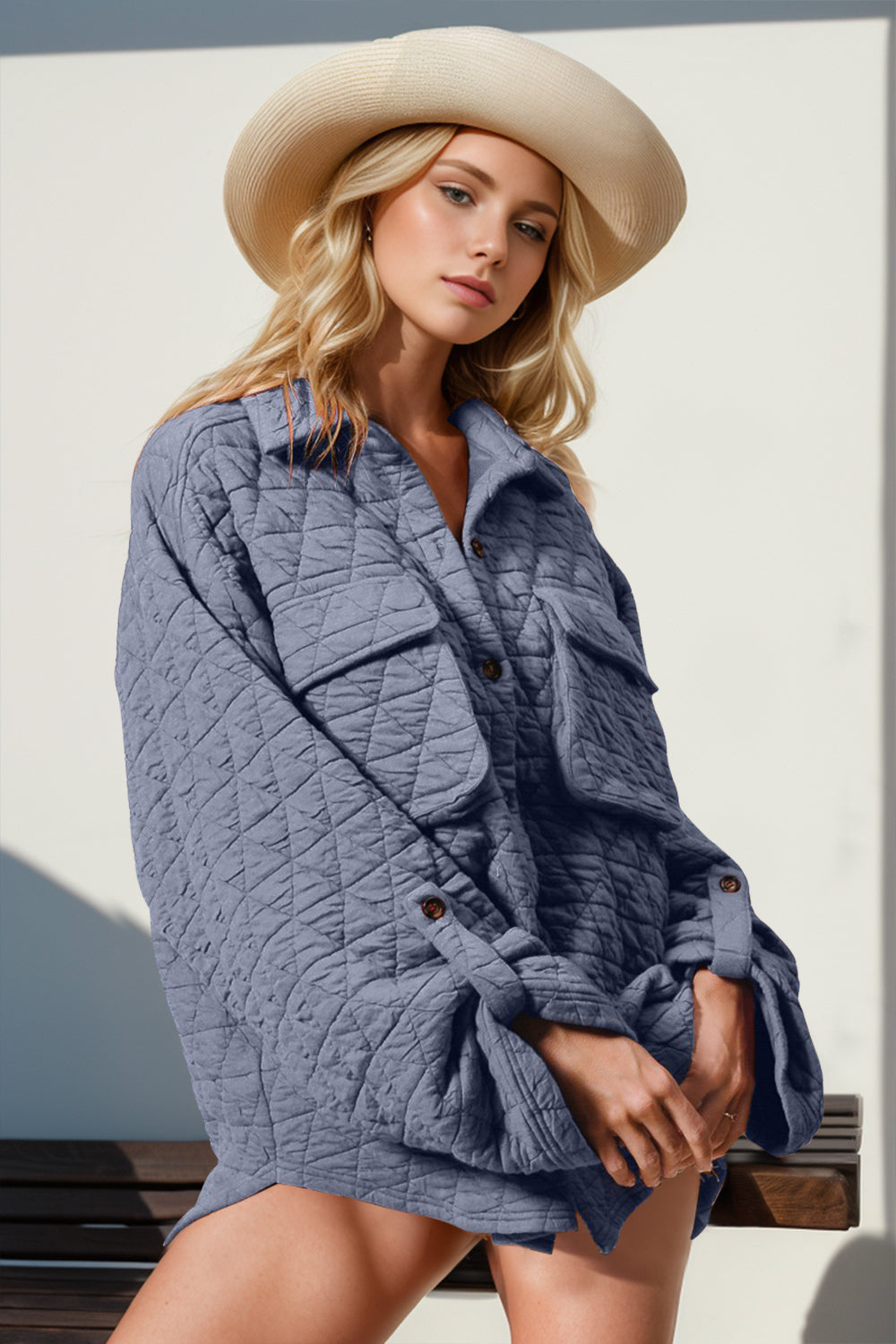 Diamond-quilted oversized shacket in dusty blue with patch pockets and button front.