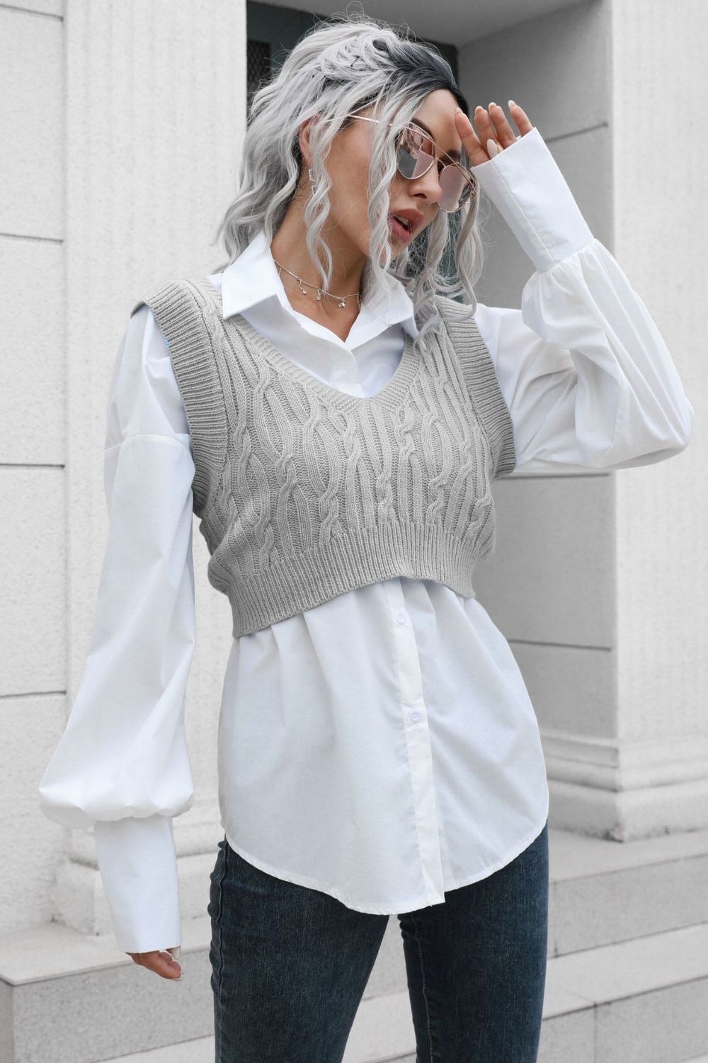 Gray cropped cable knit V-neck vest with a white button-up shirt.