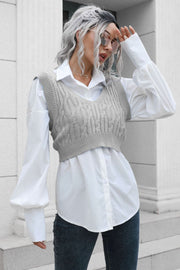 Gray cropped cable knit V-neck vest with a white button-up shirt.