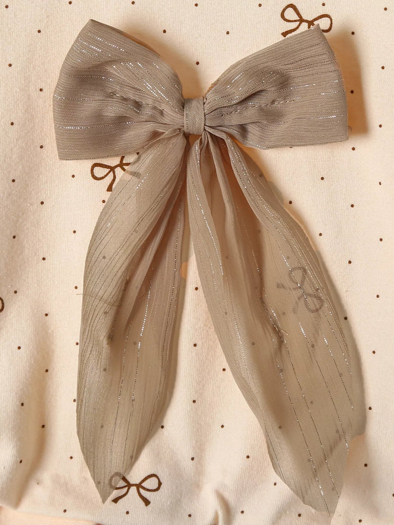 Tan baby set with polka dot pattern and large sheer bow detail.