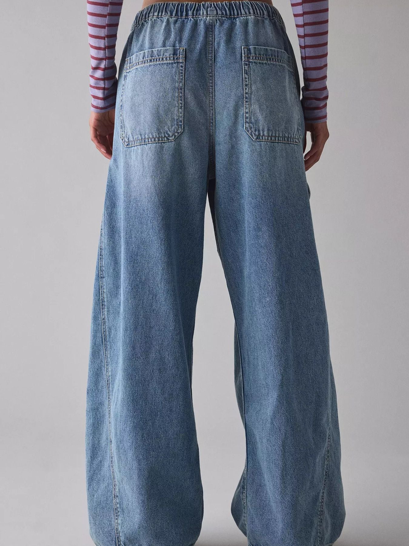 Drawstring waist cargo jeans in dusty blue denim with wide legs and back pockets.