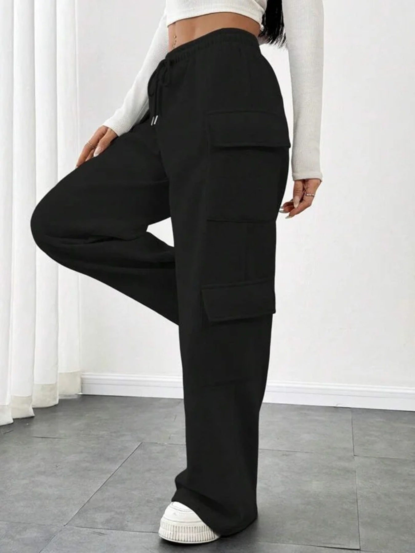 Black relaxed fit cargo pants with drawstring and multiple pockets.