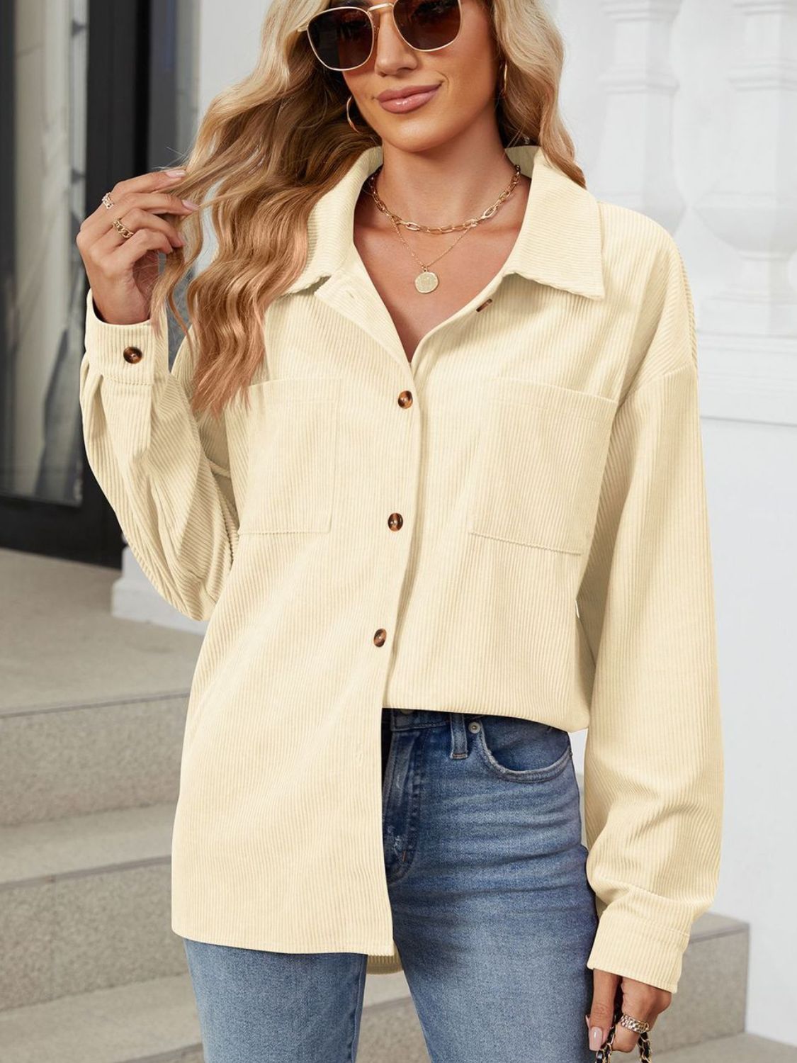Pastel yellow corduroy overshirt with buttoned patch pockets and long sleeves.