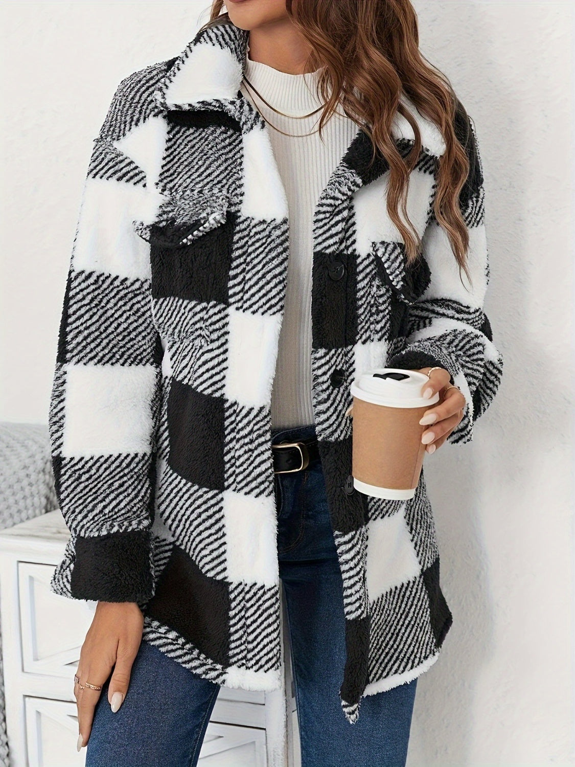 Oversized black and white checkerboard sherpa shacket with button front and chest pockets.