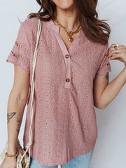 Pink eyelet embroidered short-sleeve blouse with button detail and v-neck.
