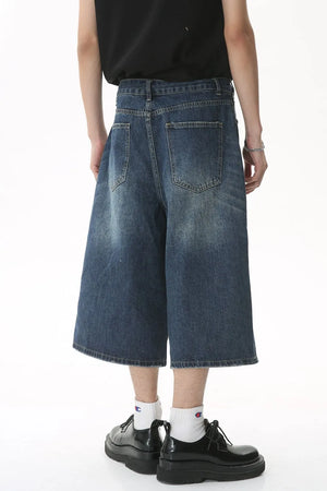 Wide-leg denim culottes in light blue with a relaxed fit and distressed details.
