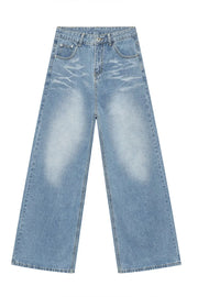 Oversized denim palazzo jeans in medium wash with subtle fading and wide legs.