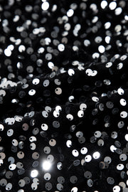 Black sweatshirt with all-over silver sequin embellishments and ribbed cuffs.