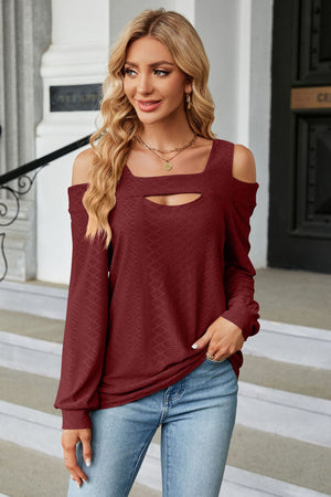 Burgundy textured open shoulder blouse with keyhole neckline and long sleeves.
