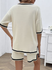 Cream knit loungewear set with black contrast trim on neckline, sleeves, and shorts.