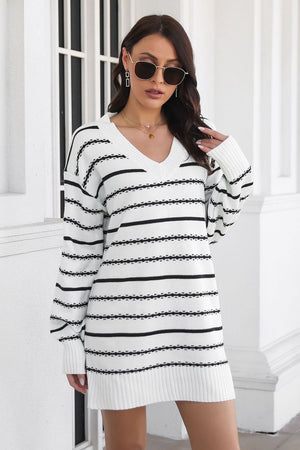 Textured stripe knit mini dress in white and black with a V-neck and long sleeves.