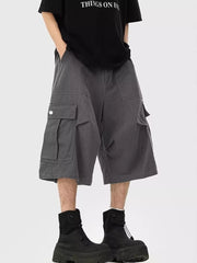 Dark gray relaxed fit cargo cropped sweatpants with large side pockets.