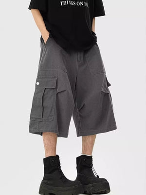 Dark gray relaxed fit cargo cropped sweatpants with large side pockets.