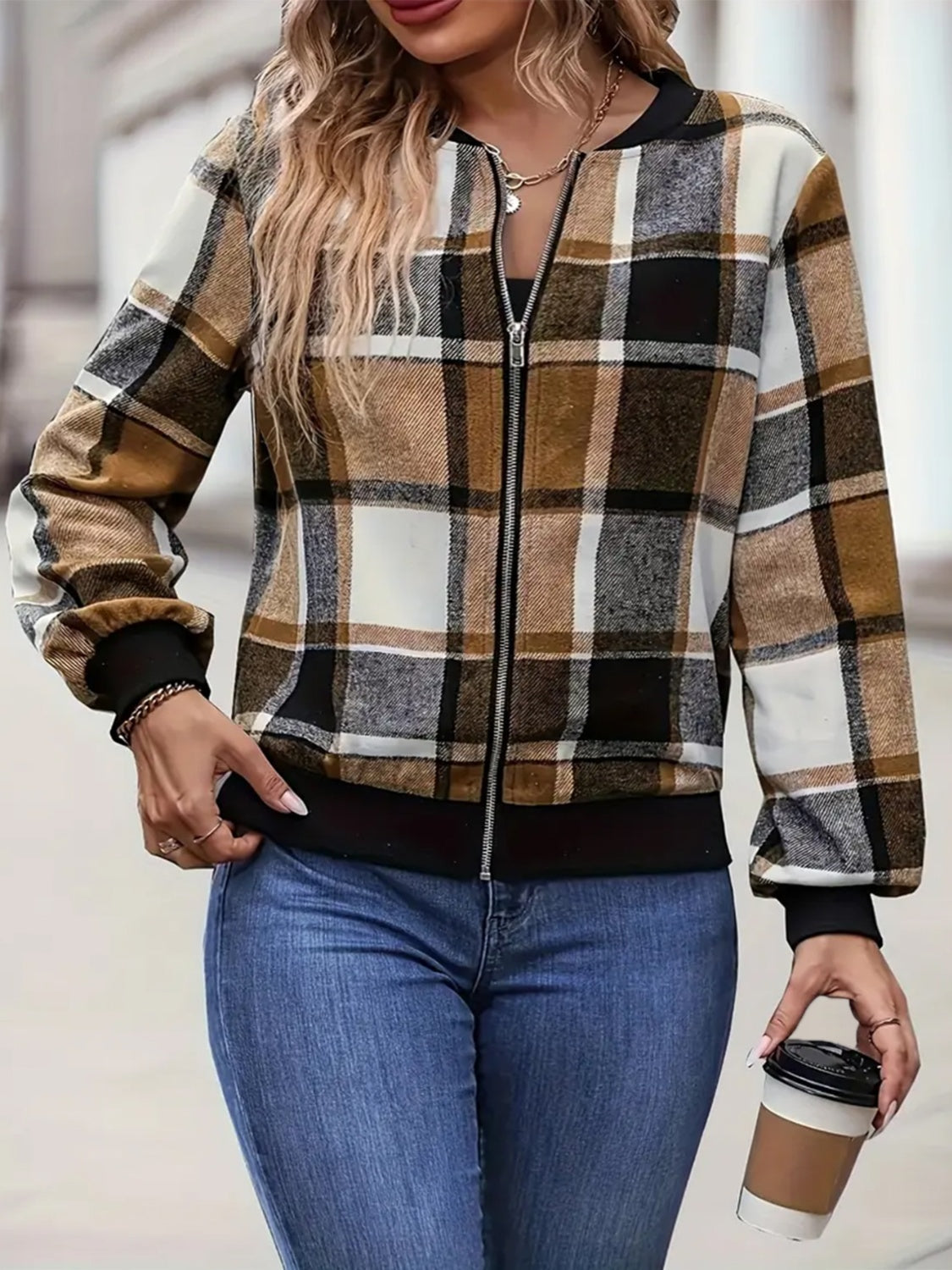 Plaid bomber jacket in caramel with ribbed cuffs and zipper closure.