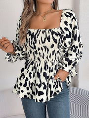 Cream and black animal print smocked bodice square neck blouse with long sleeves.