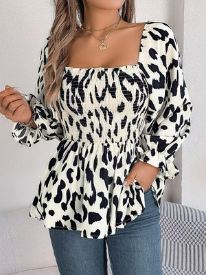 Cream and black animal print smocked bodice square neck blouse with long sleeves.