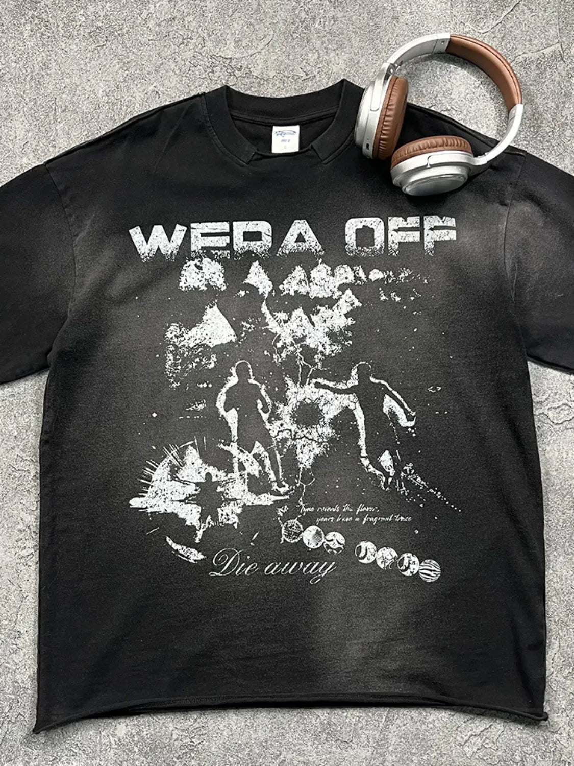 Black graphic tee with distressed "Wera Off" print and abstract figures.