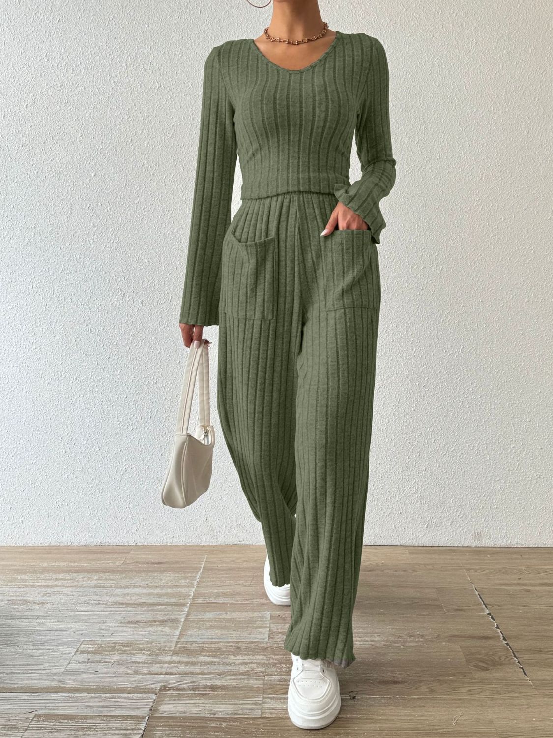 Moss green ribbed knit lounge set with v-neck top and wide-leg pants with pockets.