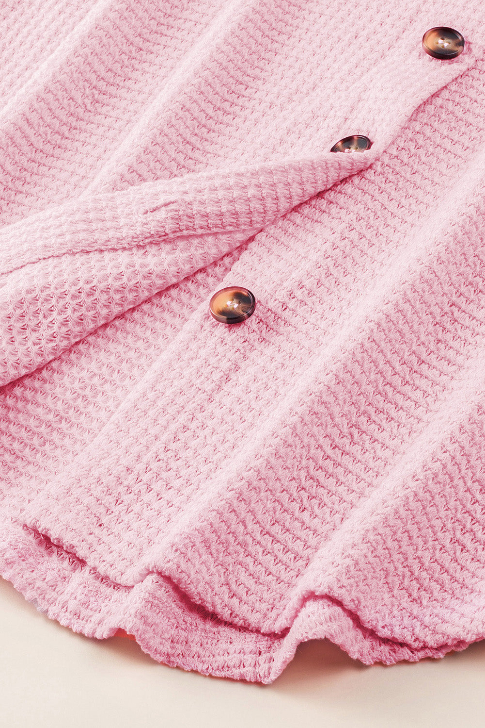 Blush pink waffle knit button-down shirt jacket with tortoise shell buttons.