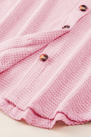 Blush pink waffle knit button-down shirt jacket with tortoise shell buttons.