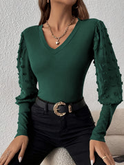 Dark green ribbed v-neck bodysuit with sheer pom-pom detail sleeves