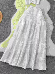 White textured two-piece set with ruffled details and smocked bodice