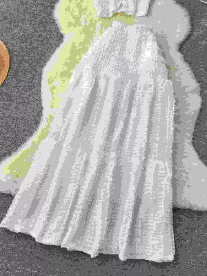 White textured two-piece set with ruffled details and smocked bodice