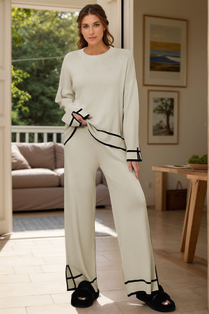 Cream acrylic loungewear set with round neck top and wide leg pants, featuring black trim detail.