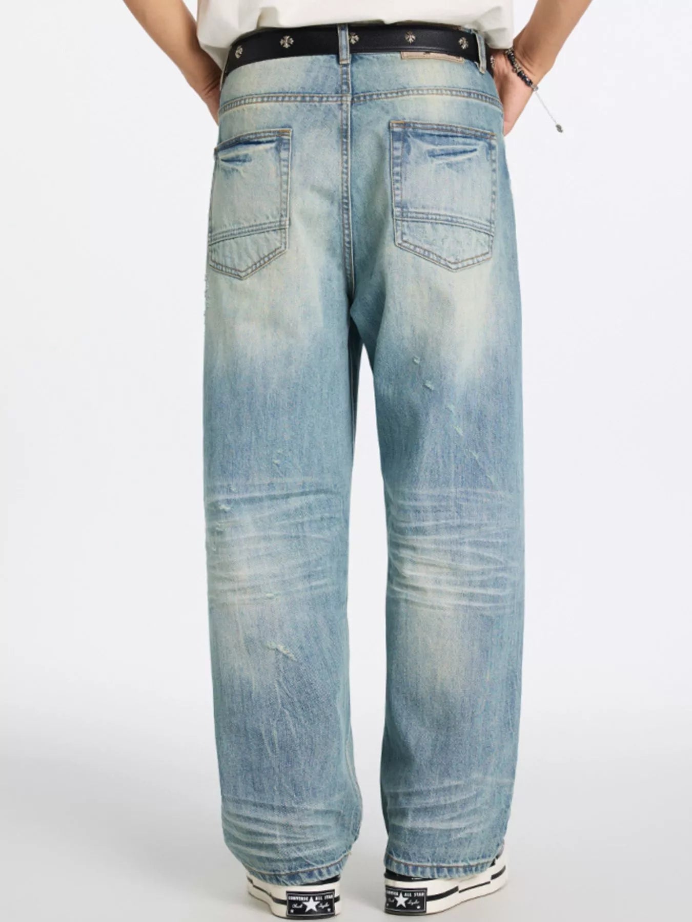 Men's relaxed wide-leg jeans in blue denim with distressed details and a faded wash.