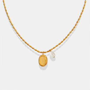 Gold oval medallion and pearl accent necklace with beaded chain