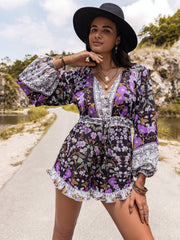 Floral print blouson sleeve romper with tie waist and ruffled hem.