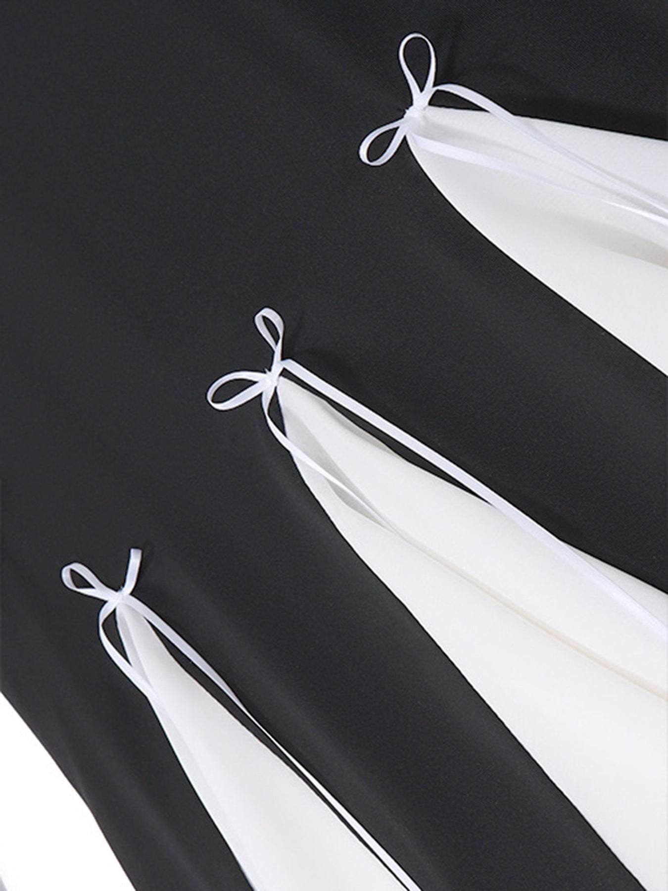 Black mini dress with white contrast panels and bowknot details