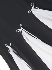 Black mini dress with white contrast panels and bowknot details