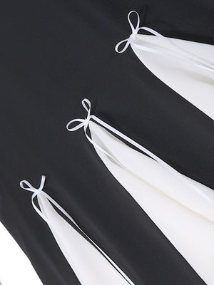 Black mini dress with white contrast panels and bowknot details