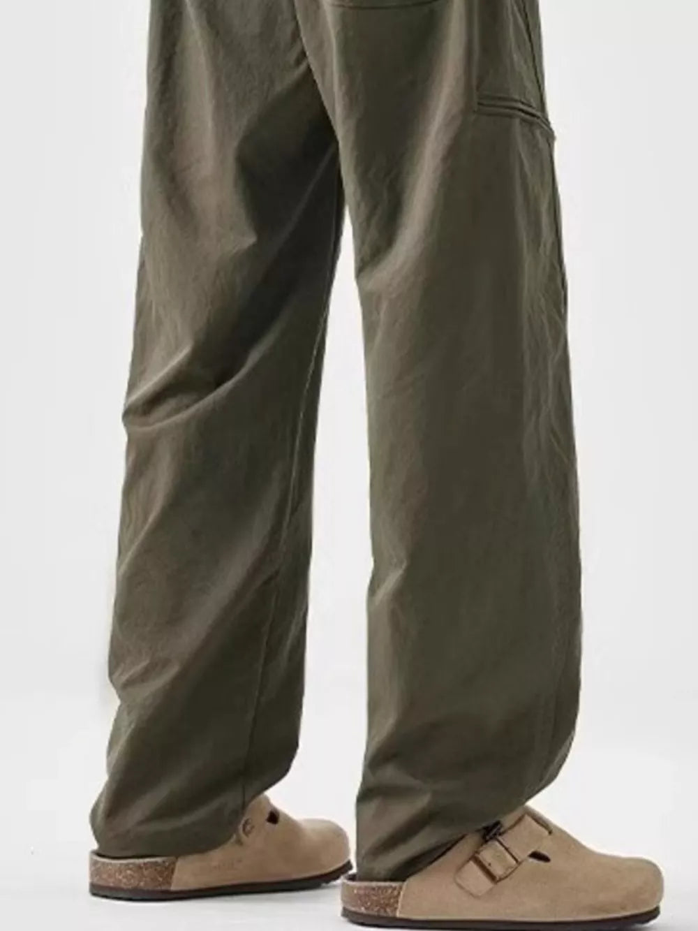 Olive green wide-leg sweatpants with drawstring detail and cargo pocket.