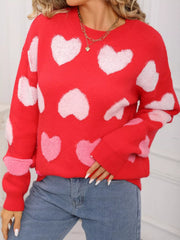 Red fuzzy knit sweater with allover pink and white hearts, crew neck, long sleeves.